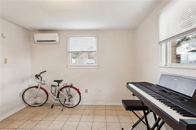 miscellaneous room with an AC wall unit and light tile patterned floors