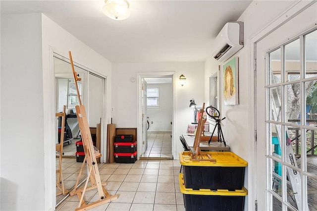 interior space featuring tile patterned flooring and a wall unit AC