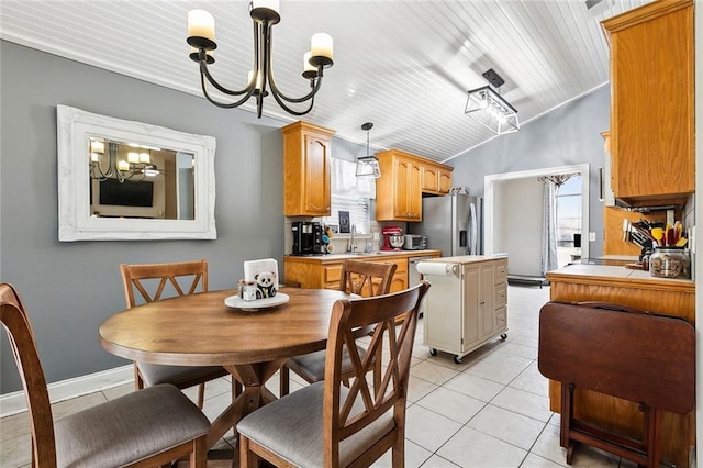 dining space with wooden ceiling, a notable chandelier, light tile patterned flooring, lofted ceiling, and sink