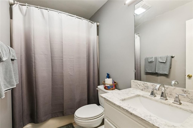 bathroom featuring toilet and vanity