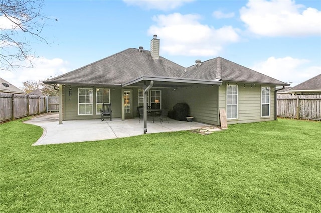 back of house with a patio area and a yard