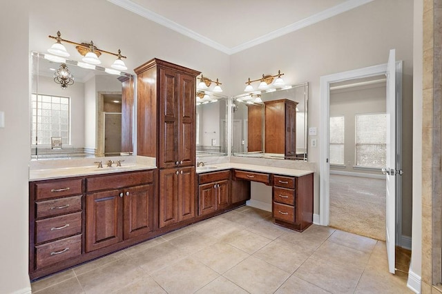 bathroom with vanity, tile patterned floors, a shower with door, and crown molding