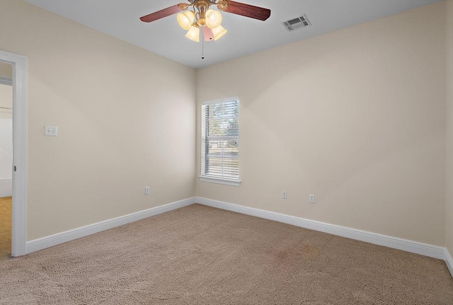 carpeted spare room featuring ceiling fan