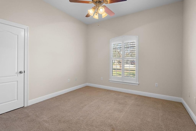 carpeted spare room featuring ceiling fan