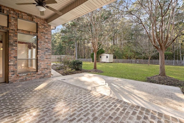 view of patio featuring ceiling fan and a storage unit