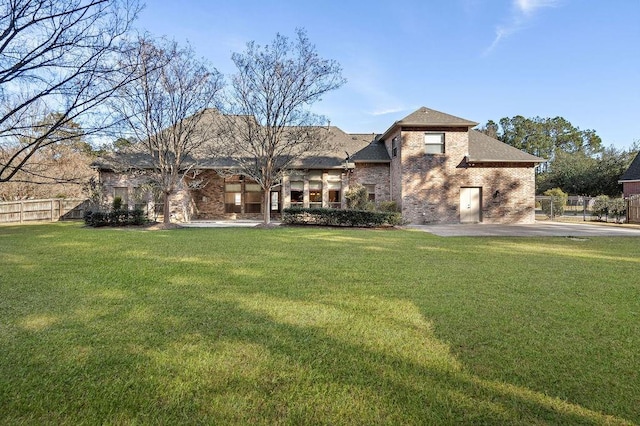 view of front of home with a front yard and a patio area