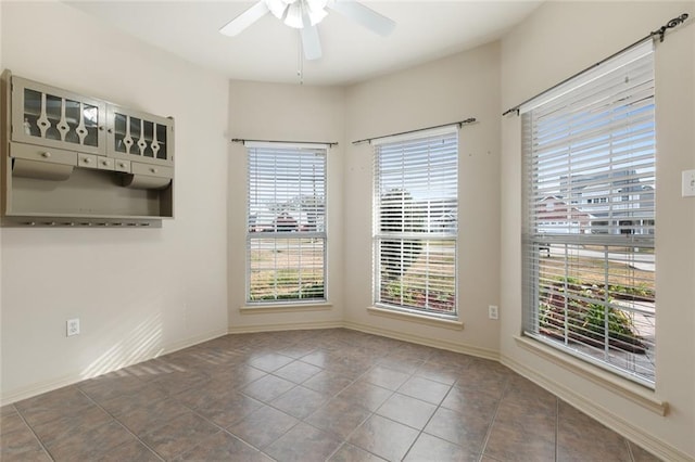 spare room featuring ceiling fan and tile patterned floors