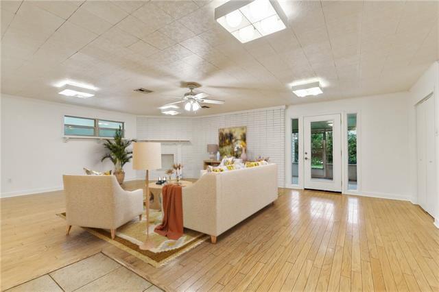 living room featuring light wood-type flooring and ceiling fan