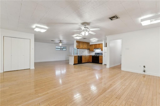 unfurnished living room featuring ceiling fan and light hardwood / wood-style flooring