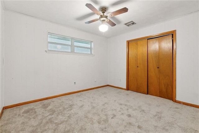 unfurnished bedroom with light carpet, a closet, and ceiling fan