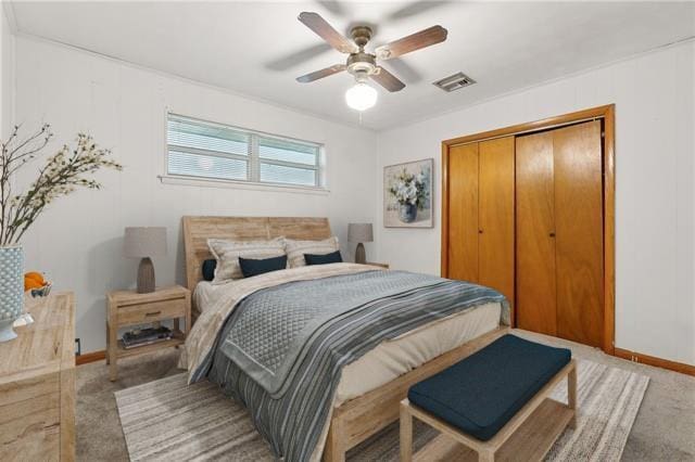 bedroom with ceiling fan, carpet, and a closet