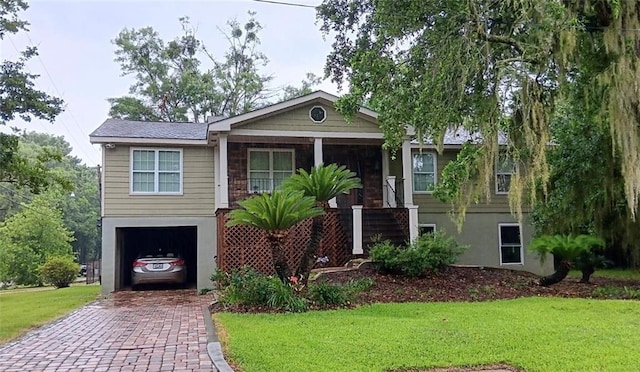 view of front of home with a front yard and a garage