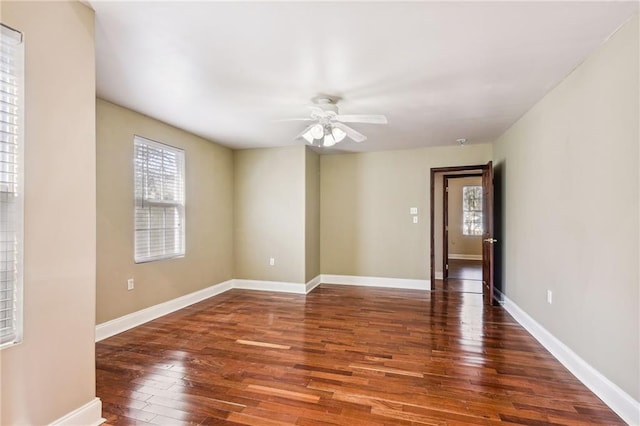 empty room featuring ceiling fan and dark hardwood / wood-style floors