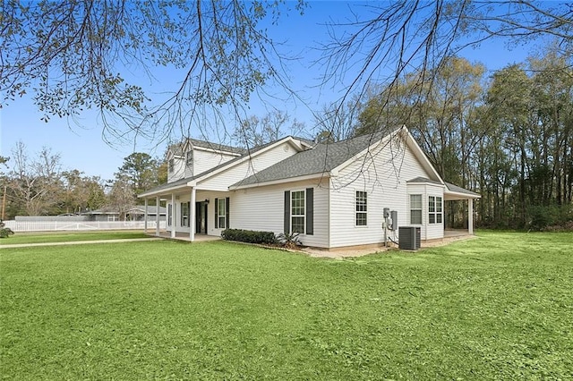 exterior space with a lawn and central AC unit