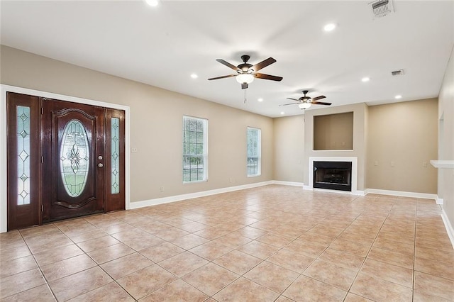 tiled entryway featuring ceiling fan and a healthy amount of sunlight