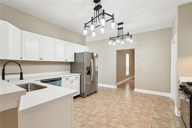 kitchen featuring pendant lighting, white cabinetry, stainless steel appliances, sink, and light tile patterned floors