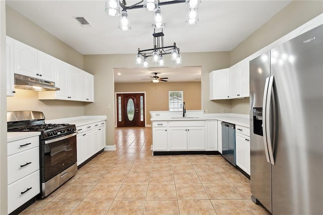 kitchen featuring ceiling fan, stainless steel appliances, white cabinets, and sink