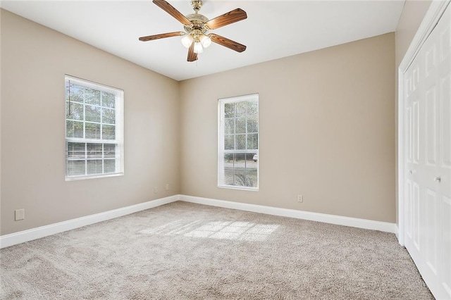 unfurnished bedroom with ceiling fan, carpet, and a closet