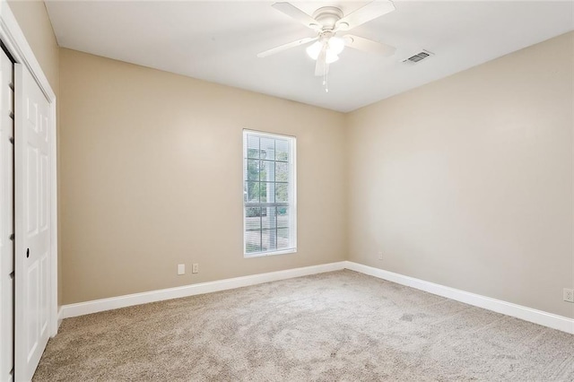 unfurnished bedroom featuring ceiling fan, a closet, and carpet floors