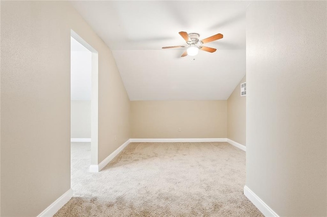 bonus room featuring ceiling fan, lofted ceiling, and light colored carpet