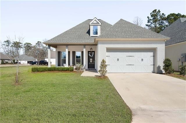 view of front of house with a front lawn and a garage