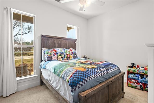 carpeted bedroom featuring ceiling fan