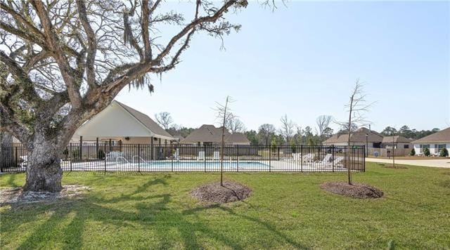 view of pool featuring a yard