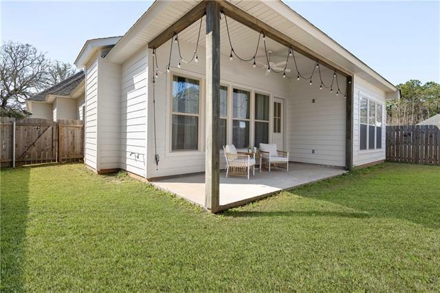 back of property featuring a patio area and a yard