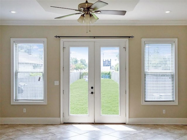 entryway with ornamental molding, a healthy amount of sunlight, and french doors