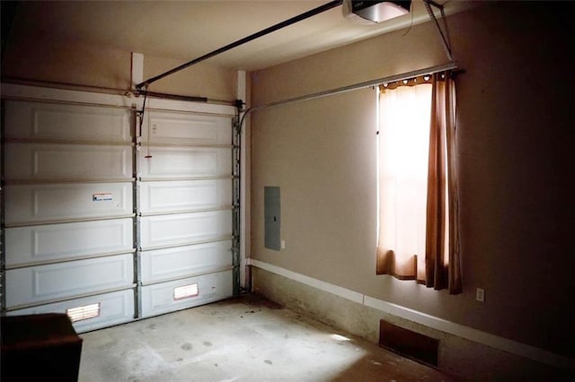 garage with electric panel and a garage door opener