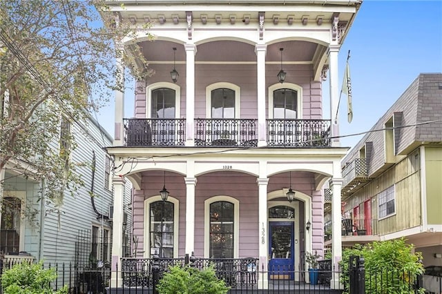 italianate home with a balcony and a porch