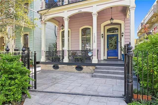 property entrance with a balcony and a porch