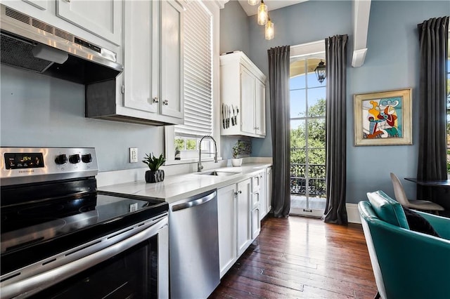 kitchen with sink, white cabinetry, appliances with stainless steel finishes, and dark hardwood / wood-style flooring