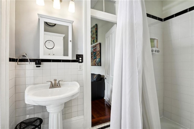 bathroom with tile walls and a shower with curtain