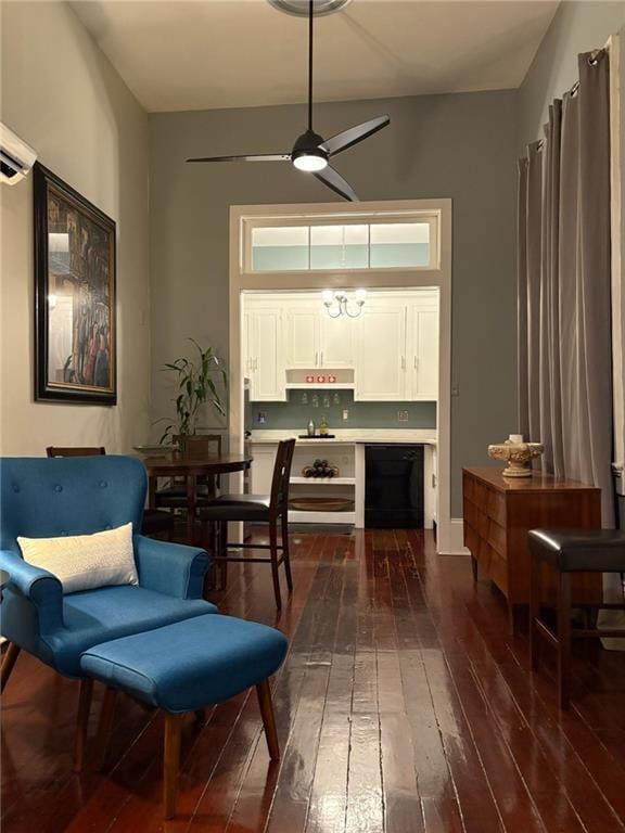 living area featuring ceiling fan and dark hardwood / wood-style flooring