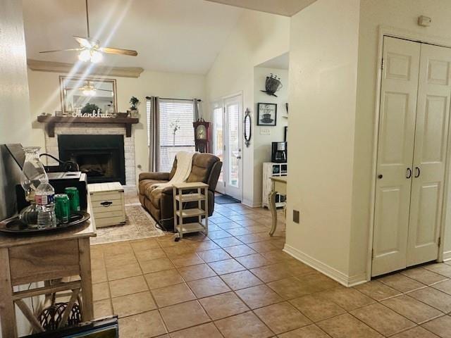 living room featuring vaulted ceiling, ceiling fan, and light tile patterned flooring