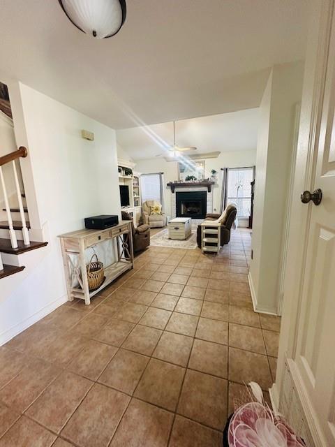 tiled living room featuring ceiling fan