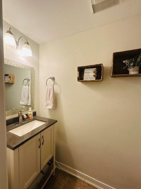 bathroom with vanity and a textured ceiling