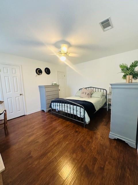 bedroom featuring ceiling fan and dark hardwood / wood-style flooring