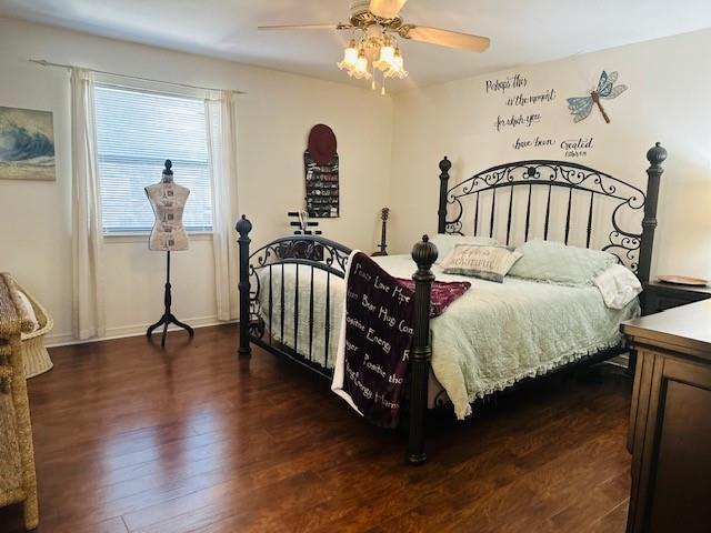 bedroom with ceiling fan and dark hardwood / wood-style flooring