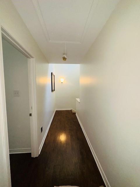 hallway with dark hardwood / wood-style flooring