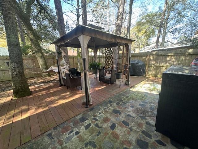 wooden terrace featuring grilling area and a gazebo