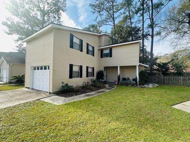 view of front of house with a front yard and a garage