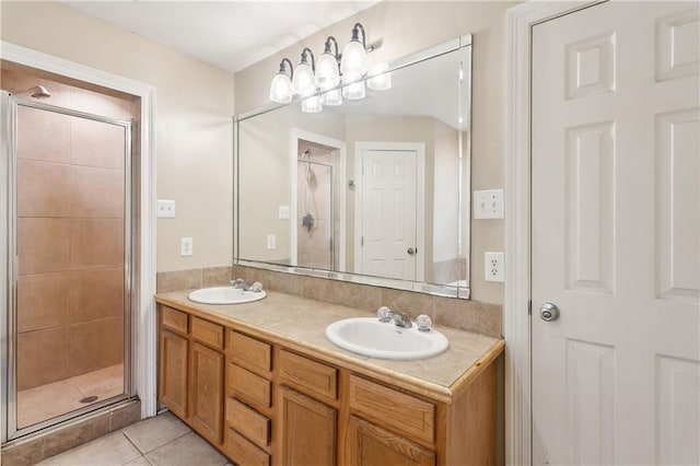 bathroom featuring a shower with shower door, vanity, and tile patterned floors