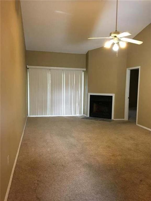 unfurnished living room with lofted ceiling, ceiling fan, and carpet