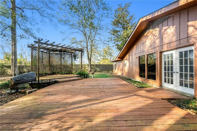 wooden deck with a pergola and french doors