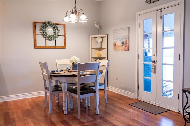 dining space featuring french doors, a notable chandelier, and wood-type flooring