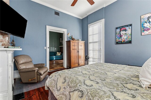 bedroom featuring ceiling fan, dark wood-type flooring, and crown molding