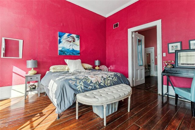 bedroom featuring crown molding and hardwood / wood-style floors