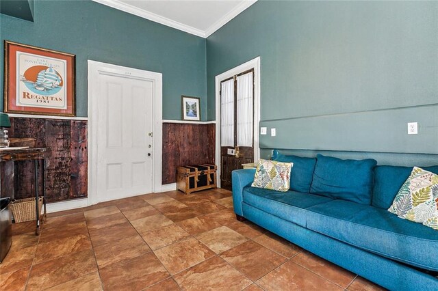 living room featuring wood walls and crown molding